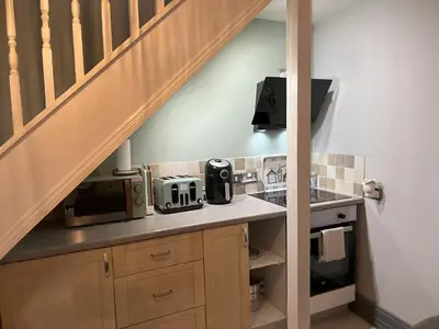 a kitchen with a counter with a sink and a microwave at The Bakehouse in Harwich