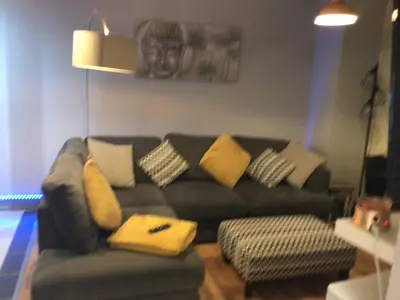 a living room with a couch with pillows on it at The Bakehouse in Harwich