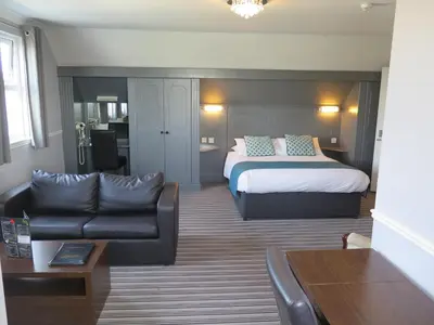 a hotel room with a bed and a couch at Oyster Fleet Hotel in Canvey Island