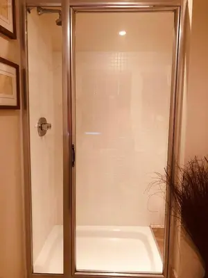 a shower with a glass door in a bathroom at The Blue Cow in Fenstanton