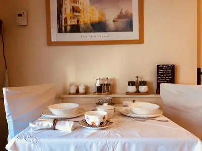 a table with bowls and plates on top of it at The Blue Cow in Fenstanton