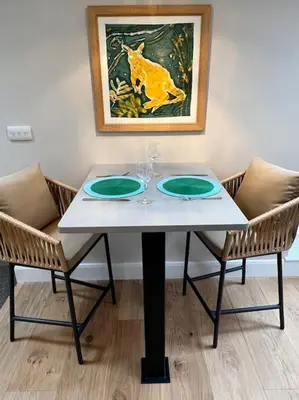 a white table with two glasses and two chairs at The Nest-Cambridge in Cambridge