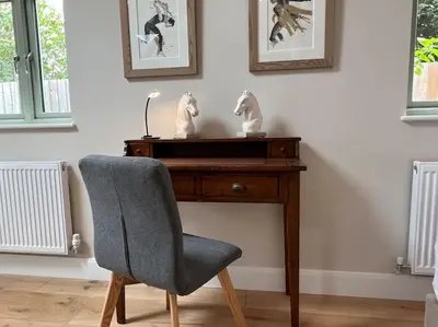 a desk with a chair and a desk with two statues on it at The Nest-Cambridge in Cambridge