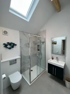 a bathroom with a shower and a toilet and a sink at The Nest-Cambridge in Cambridge