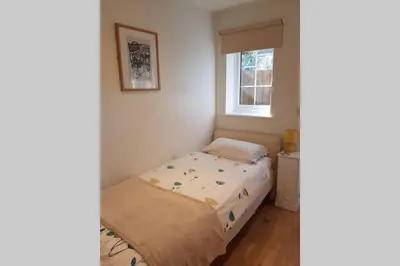a small bedroom with a bed and a window at Cosy, self contained annex in Cambridge