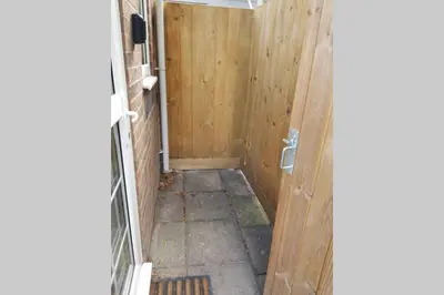 a hallway with a wooden door in a house at Cosy, self contained annex in Cambridge