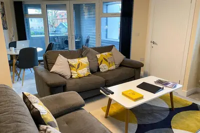 a living room with a couch and a table at 13 The Grosvenor, luxury flat, central Newmarket, in Newmarket