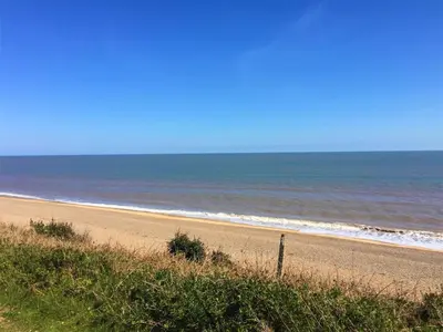 an empty beach with the ocean in the background at The Dower Lodge in Sizewell
