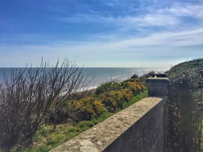 a retaining wall with a view of the ocean at The Dower Lodge in Sizewell