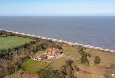 an aerial view of a house next to the ocean at The Dower Lodge in Sizewell