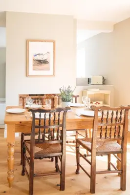 a dining room with a wooden table and chairs at The Dower Lodge in Sizewell