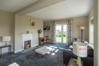 a living room with a couch and a fireplace at The Dower House in Sizewell