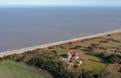 an aerial view of a house next to the ocean at The Dower Retreat in Sizewell