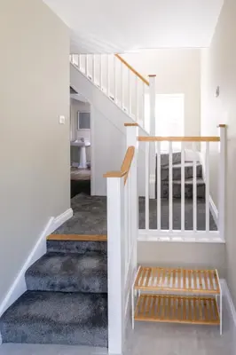 a staircase in a house with white walls at The Dower Retreat in Sizewell