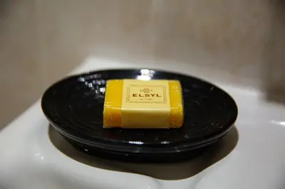 a black plate with a piece of cheese on it at Velvet 1-bedroom apartment, Clockhouse, Hoddesdon in Hoddesdon
