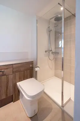 a bathroom with a toilet and a shower at Mansard House in Aldeburgh