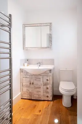 a bathroom with a sink and a toilet at Mansard House in Aldeburgh