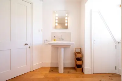 a bathroom with a white sink in a room at Mansard House in Aldeburgh
