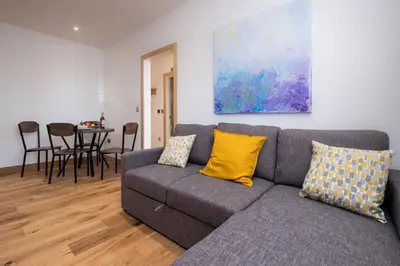 a living room with a couch and a table at Three Tuns Apartments - Hazel - Aldeburgh Coastal Cottages in Pettistree