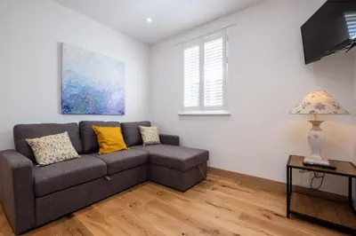 a living room with a couch and a table at Three Tuns Apartments - Hazel - Aldeburgh Coastal Cottages in Pettistree