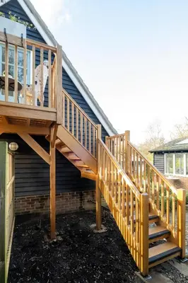 a wooden deck on the side of a house at The Bay Tree Studio in Thorpeness