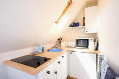 a small kitchen with a sink and a microwave at The Bay Tree Studio in Thorpeness