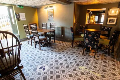 a dining room with a table and chairs at Kings Arms Hotel in Stansted Mountfitchet