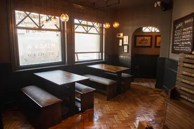 a restaurant with two tables and chairs and a window at Kings Arms Hotel in Stansted Mountfitchet