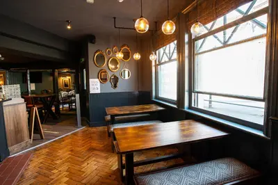 a dining room with a table and a window at Kings Arms Hotel in Stansted Mountfitchet