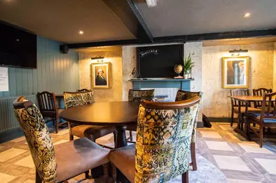 a dining room with a table and chairs at Kings Arms Hotel in Stansted Mountfitchet