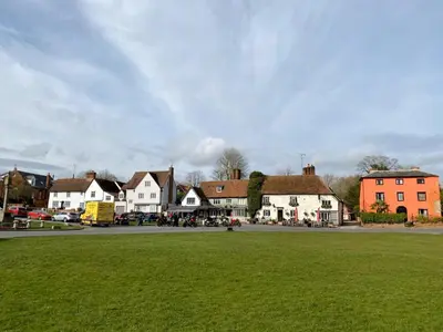 a town with a green field and houses on a street at Millie's Cottage in Finchingfield