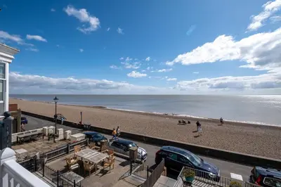 a view of a beach with cars parked on it at Crags Nest in Aldeburgh