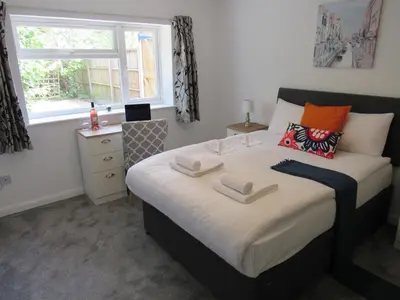 a bedroom with a bed with two towels on it at The Cambridge Suites - Tas Accommodations in Cambridge