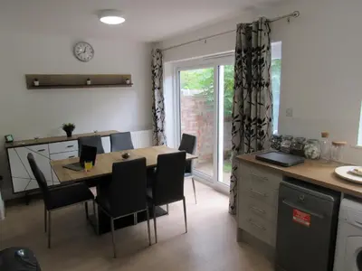 a kitchen and dining room with a table and chairs at The Cambridge Suites - Tas Accommodations in Cambridge
