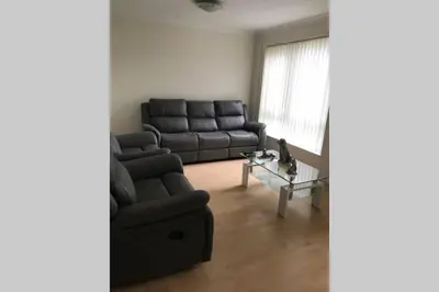 a living room with a couch and a table at A Home Away from Home in Ipswich