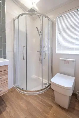 a bathroom with a shower and a toilet at Hunky-Dory - Aldeburgh Coastal Cottages in Sizewell