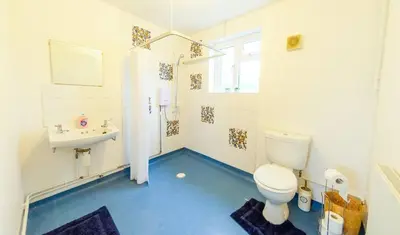 a bathroom with a toilet and a sink at 4 Bed - 2 Baths 1 Walk In Shower Lots Of Parking in Ipswich