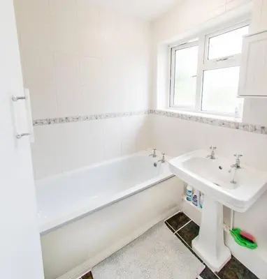 a bathroom with a tub and a sink at 4 Bed - 2 Baths 1 Walk In Shower Lots Of Parking in Ipswich