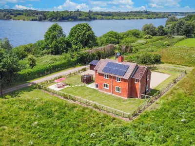 an aerial view of a house with a solar roof at Old Alton Hall Farmhouse in Tattingstone