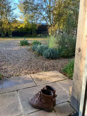 a pair of shoes sitting on a stone patio at Chestnut Cottage at Gravel Farm in Stretham
