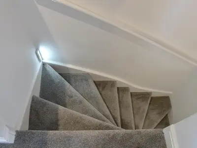 a spiral staircase with a light at the top at Hidden Gem in Willingham