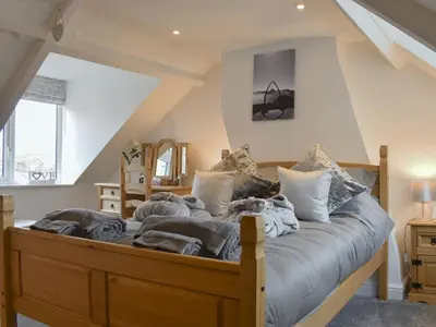 a bedroom with a large wooden bed with pillows at Hidden Gem in Willingham