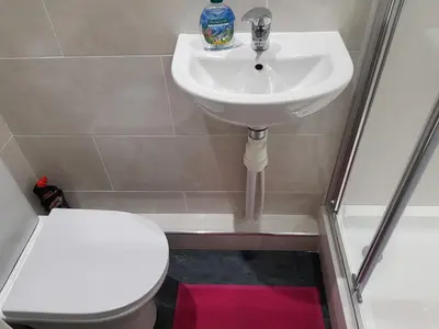 a bathroom with a sink and a toilet at Taj Suite in Ipswich