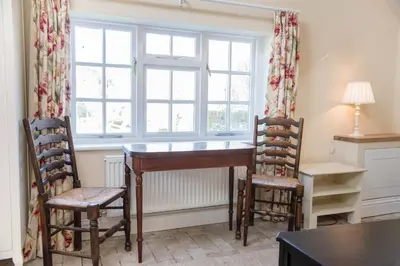a room with a desk and two chairs and a window at Mill Cottage, Tunstall in Tunstall