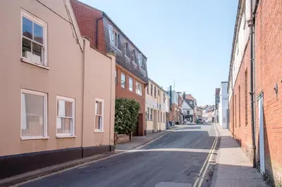 an empty street in an alley between brick buildings at Sutton House, Woodbridge in Woodbridge
