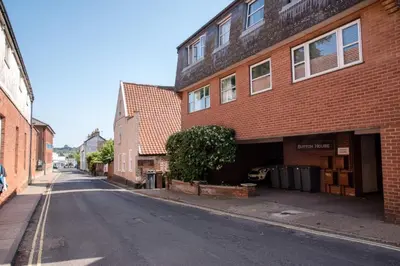 an empty street next to a brick building at Sutton House, Woodbridge in Woodbridge