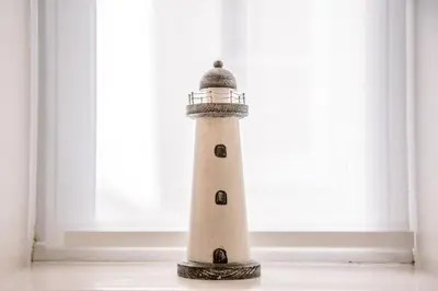 a lighthouse sitting in front of a window at Tower House, Aldeburgh in Aldeburgh