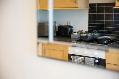 a kitchen with pots and pans on a stove at 1-bedroom apartment with balcony, Hoddesdon in Hoddesdon