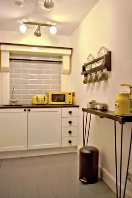 a kitchen with a yellow microwave on a counter at City Studios in Ely