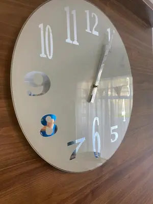 a clock that is on a wooden table at Kellys Holiday Homes 24 Willerby 2 bedrooms caravan in Weeley